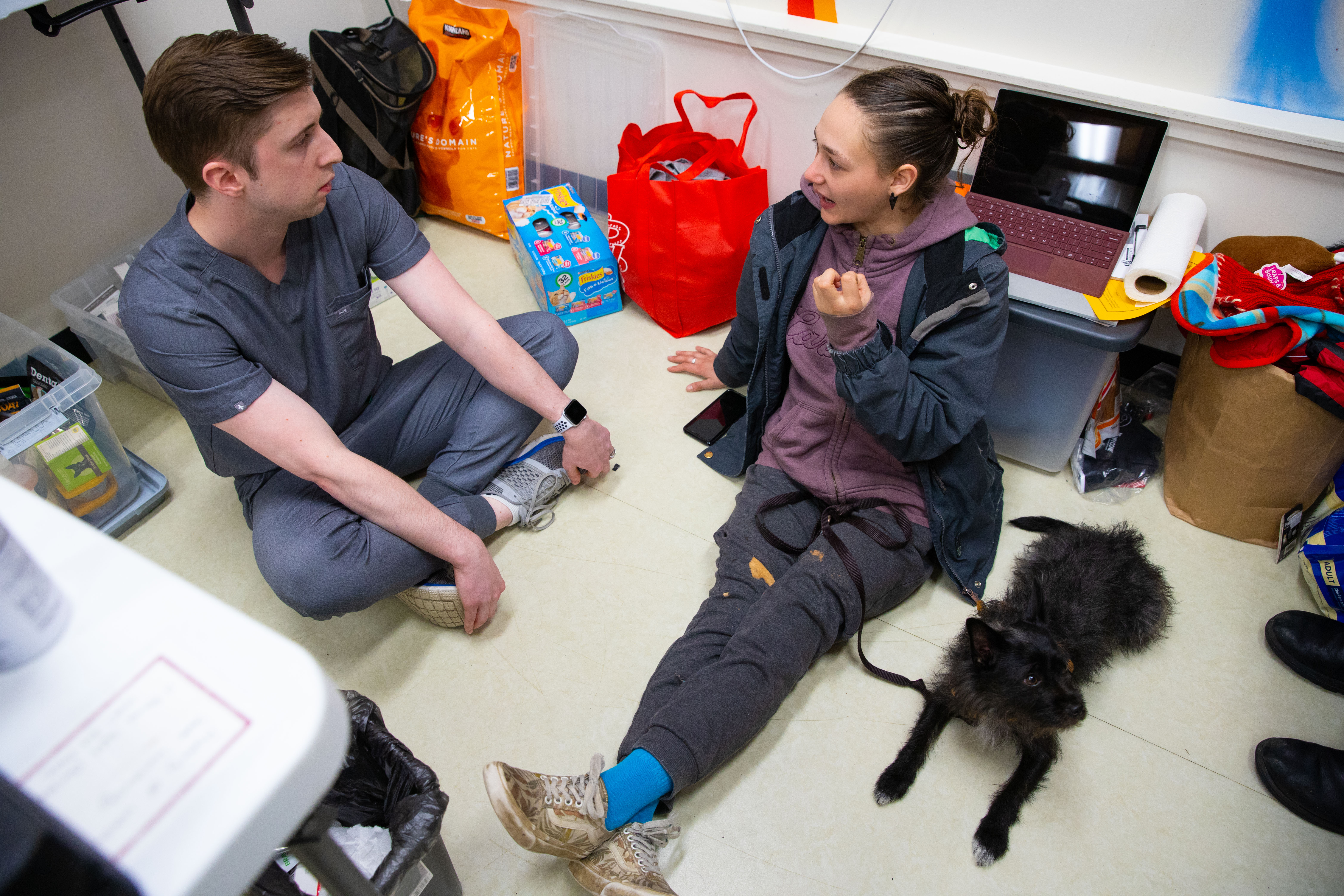 Alice Tin, MD, Katie Kuehl, DVM, and a veterinary student confer over a client pair. Photo credit: Gemina Garland-Lewis